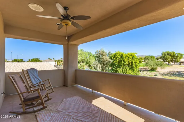 an aerial view of residential houses with outdoor space and trees