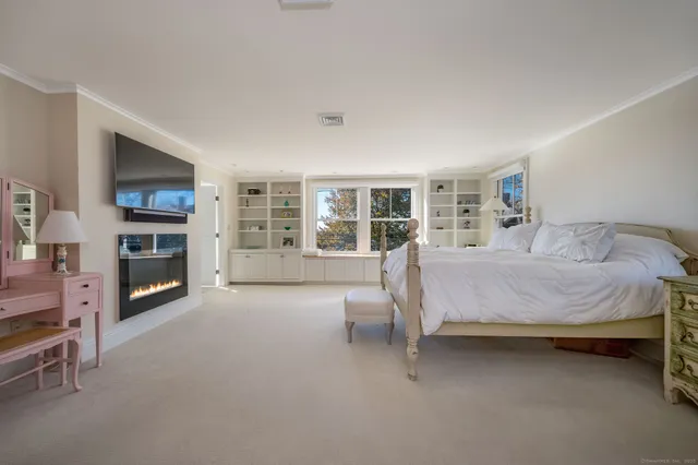 a spacious bedroom with a bed and a couch