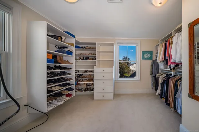 a spacious bedroom with a bed and a flat screen tv