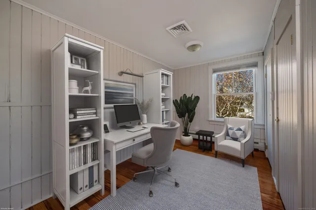 a bedroom with bed and glass window