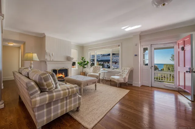 a living room with furniture fireplace and a table