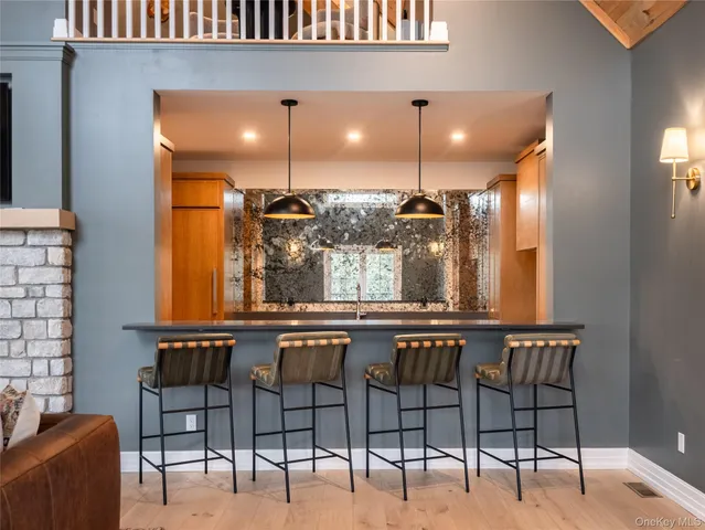 a large kitchen with stainless steel appliances a stove a sink and a refrigerator