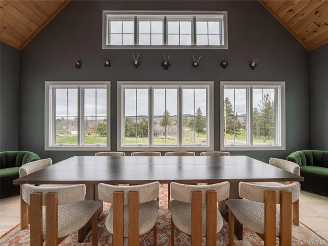 a kitchen with a dining table chairs and a chandelier
