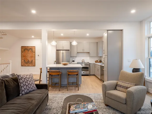 a living room with furniture a kitchen view and a kitchen view