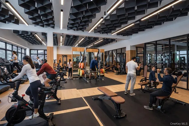 a table with wine bottles and a table in a bookshelf