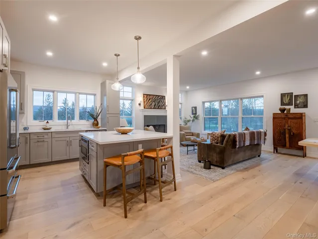a room with lots of furniture a chandelier and a fireplace