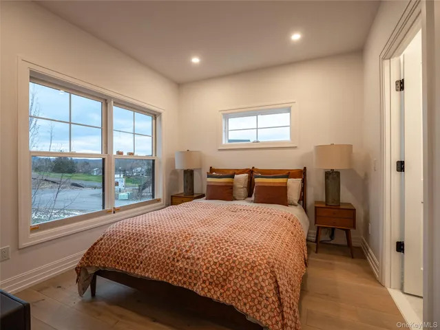 a kitchen with stainless steel appliances kitchen island granite countertop a refrigerator a stove a sink dishwasher a dining table and chairs with wooden floor