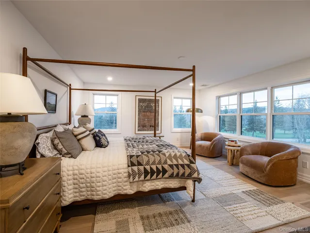 a bedroom with a bed and a large window