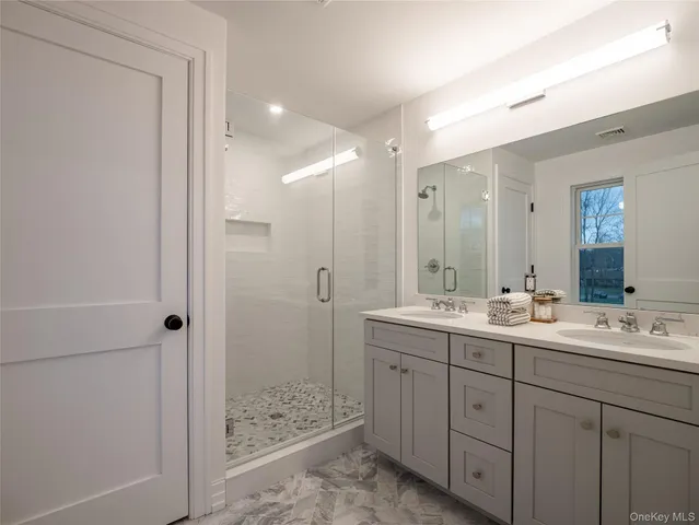 a bedroom with bed couch and window