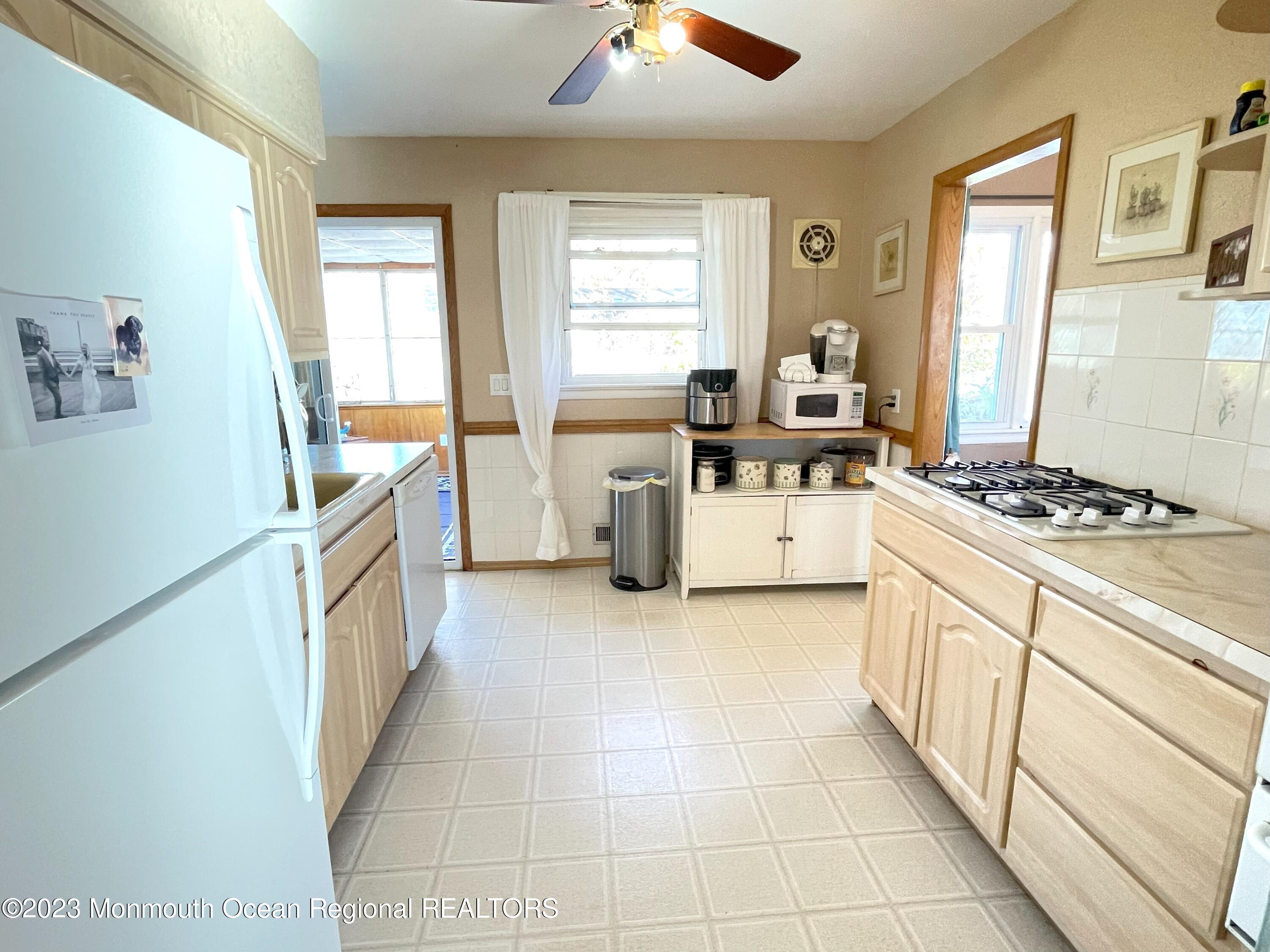 309 Midstreams Road Brick, NJ 08724 - Photo 11 of 26 a kitchen with a cabinets and white appliances