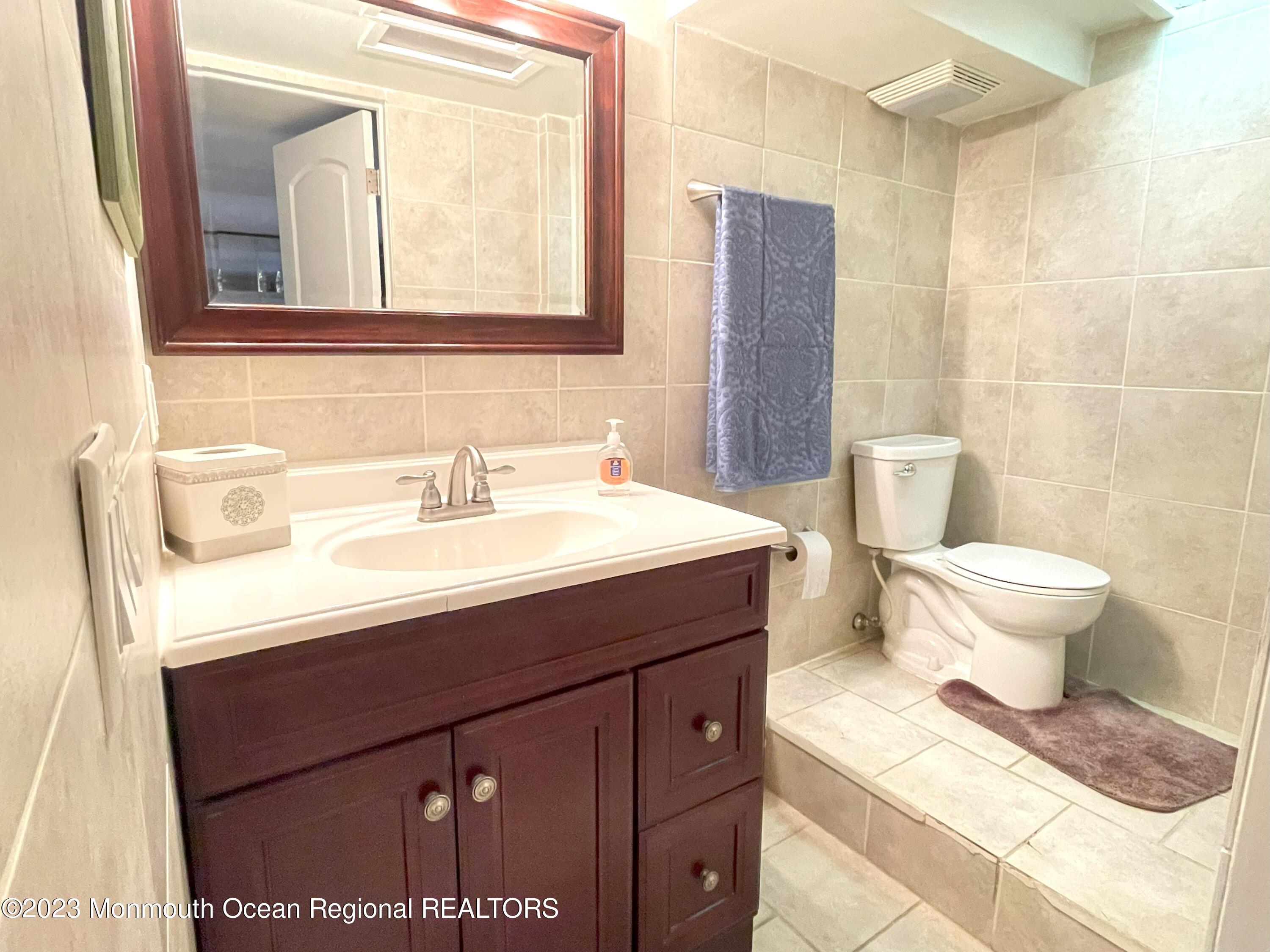 309 Midstreams Road Brick, NJ 08724 - Photo 22 of 26 a bathroom with a sink toilet and mirror