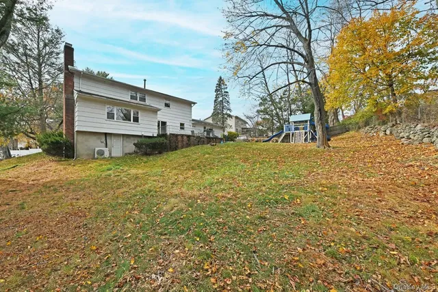 a view of a house with a yard covered with snow