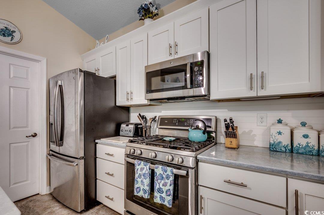 196 Rose Water Loop Myrtle Beach, SC 29588 - Photo 14 of 24 Kitchen with white cabinetry, stainless steel appl