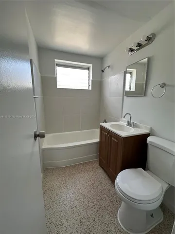 a bathroom with a toilet a sink and bathtub