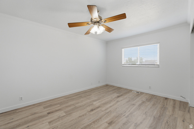 7910 Woolley Way Magna, UT 84044 - Photo 11 of 26 Spacious room featuring wood-finish flooring, white walls, and a ceiling fan with light fixture