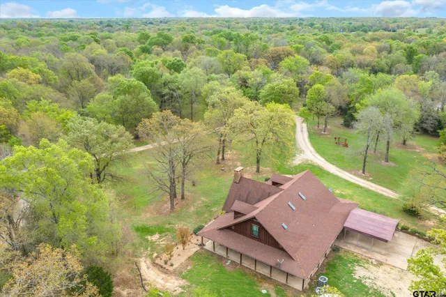 an aerial view of a house with a yard
