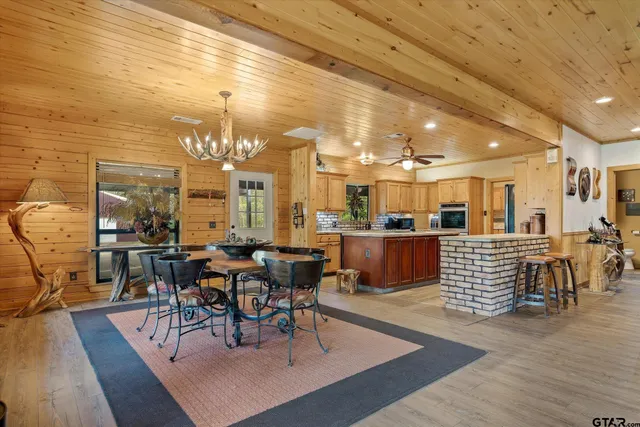 a living room with lots of furniture and kitchen view