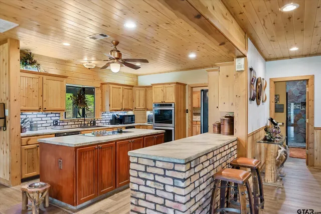a kitchen with a stove a refrigerator and a dining table