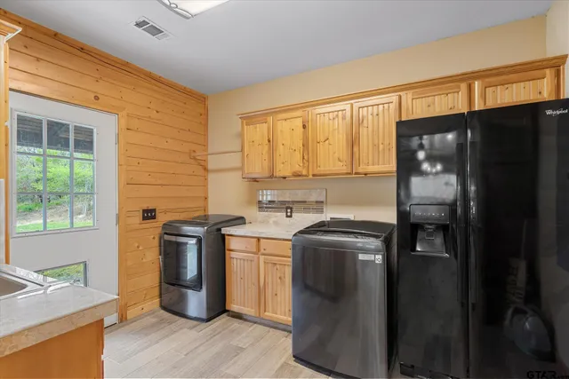 a kitchen with stainless steel appliances granite countertop a refrigerator and a sink