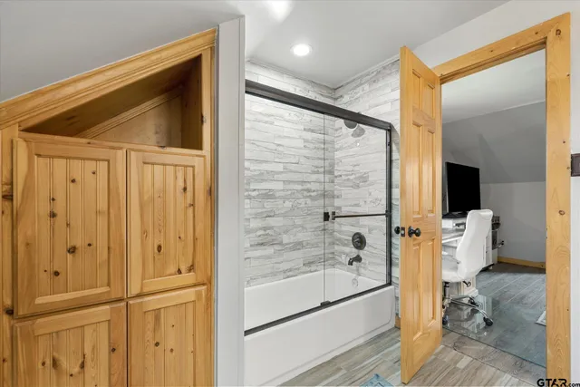 a bathroom with a bathtub and a shower