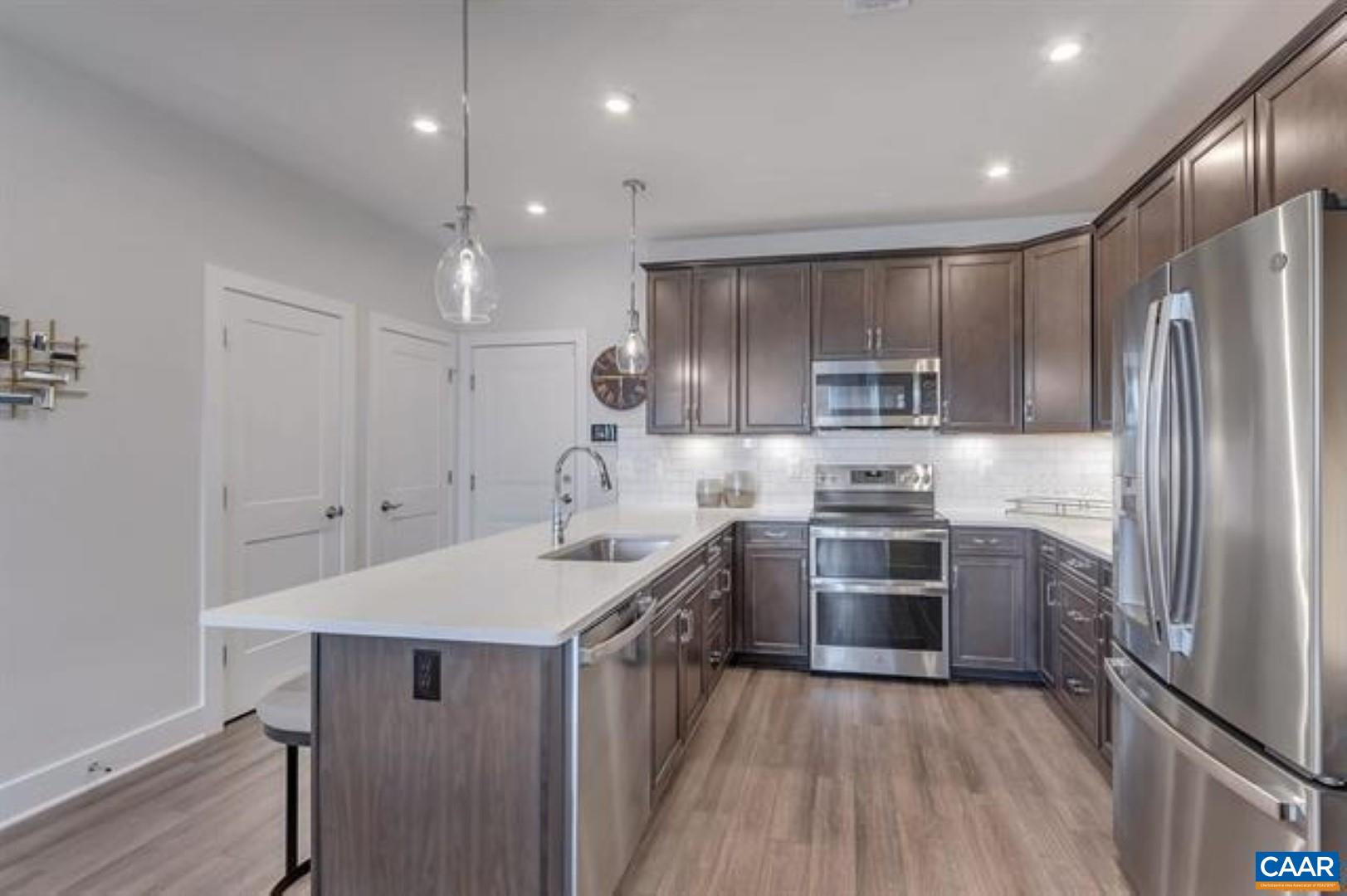 828 A Wesley Lane, Unit A Charlottesville, VA 22911 - Photo 13 of 33 a kitchen with kitchen island stainless steel appliances a sink stove and refrigerator