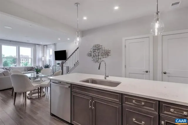 a kitchen with a sink cabinets and wooden floor