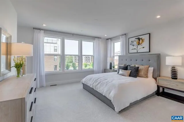 a bedroom with a large bed and a window