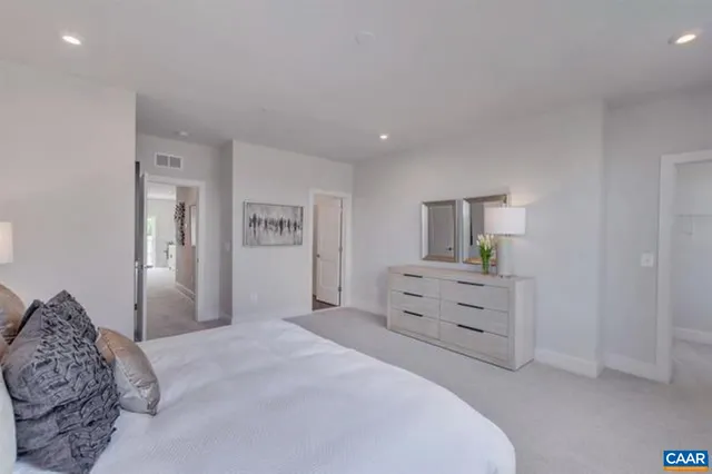 a bedroom with a bed and a dresser