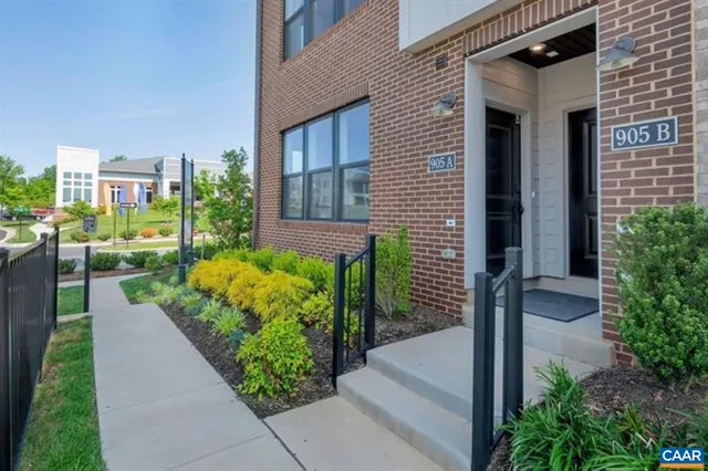 a view of a house with a small yard and a fountain