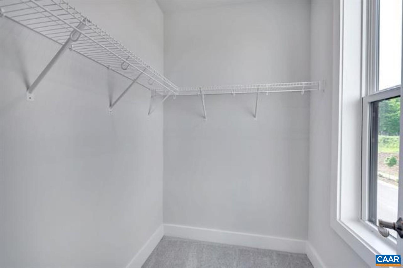 828 A Wesley Lane, Unit A Charlottesville, VA 22911 - Photo 21 of 33 a view of a room with racks on the wall