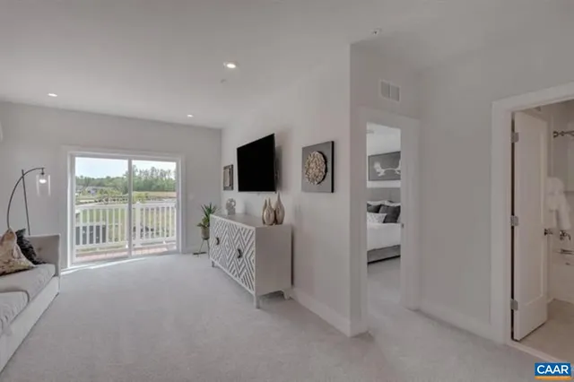 a bed room with furniture and a flat screen tv
