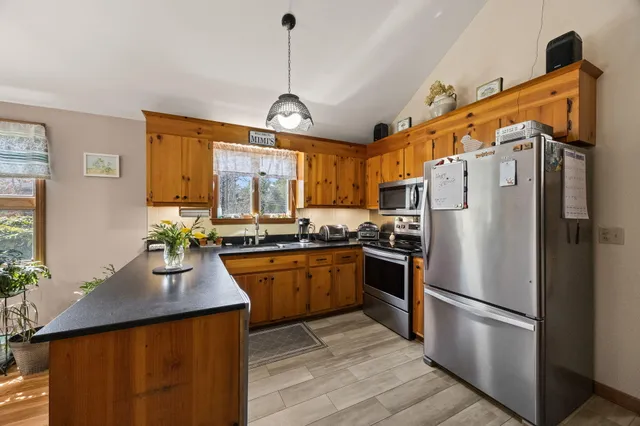 a bedroom with a bed and a flat tv screen on dresser