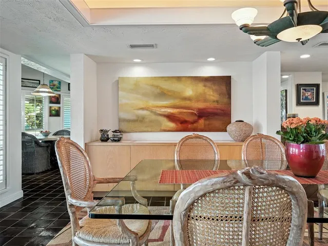 a kitchen with white cabinets and sink