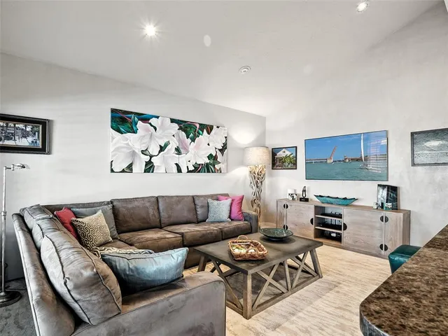 a living room with furniture and floor to ceiling windows