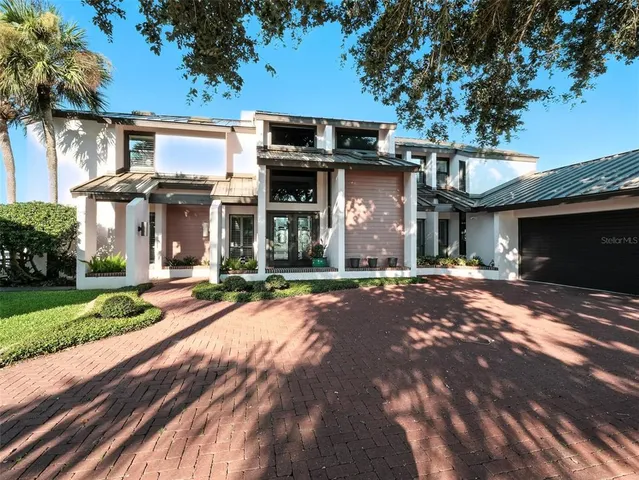 a front view of house with yard and swimming pool