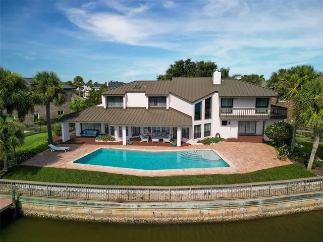 an aerial view of a house with a yard basket ball court and outdoor seating