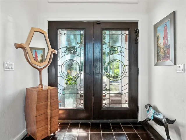 an aerial view of a residential houses with outdoor space and ocean view