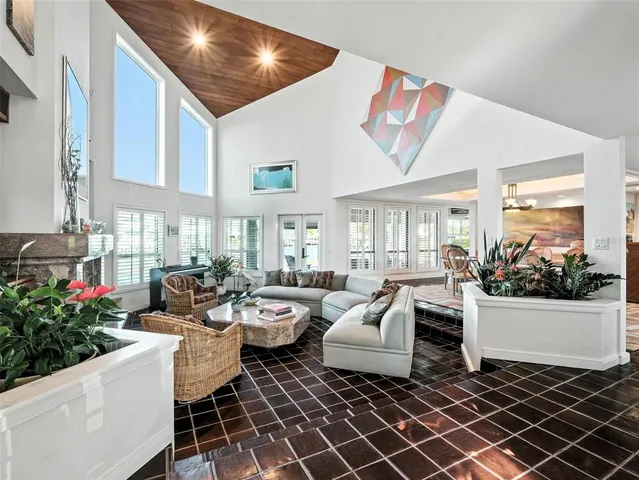 a living room with fireplace furniture and a potted plant