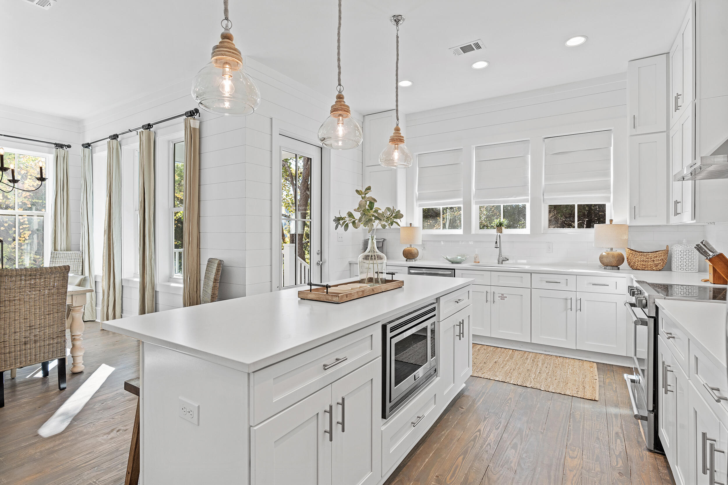 17 Pompano Court Inlet Beach, FL 32461 - Photo 19 of 48 a kitchen that has a lot of white cabinets and wooden floor