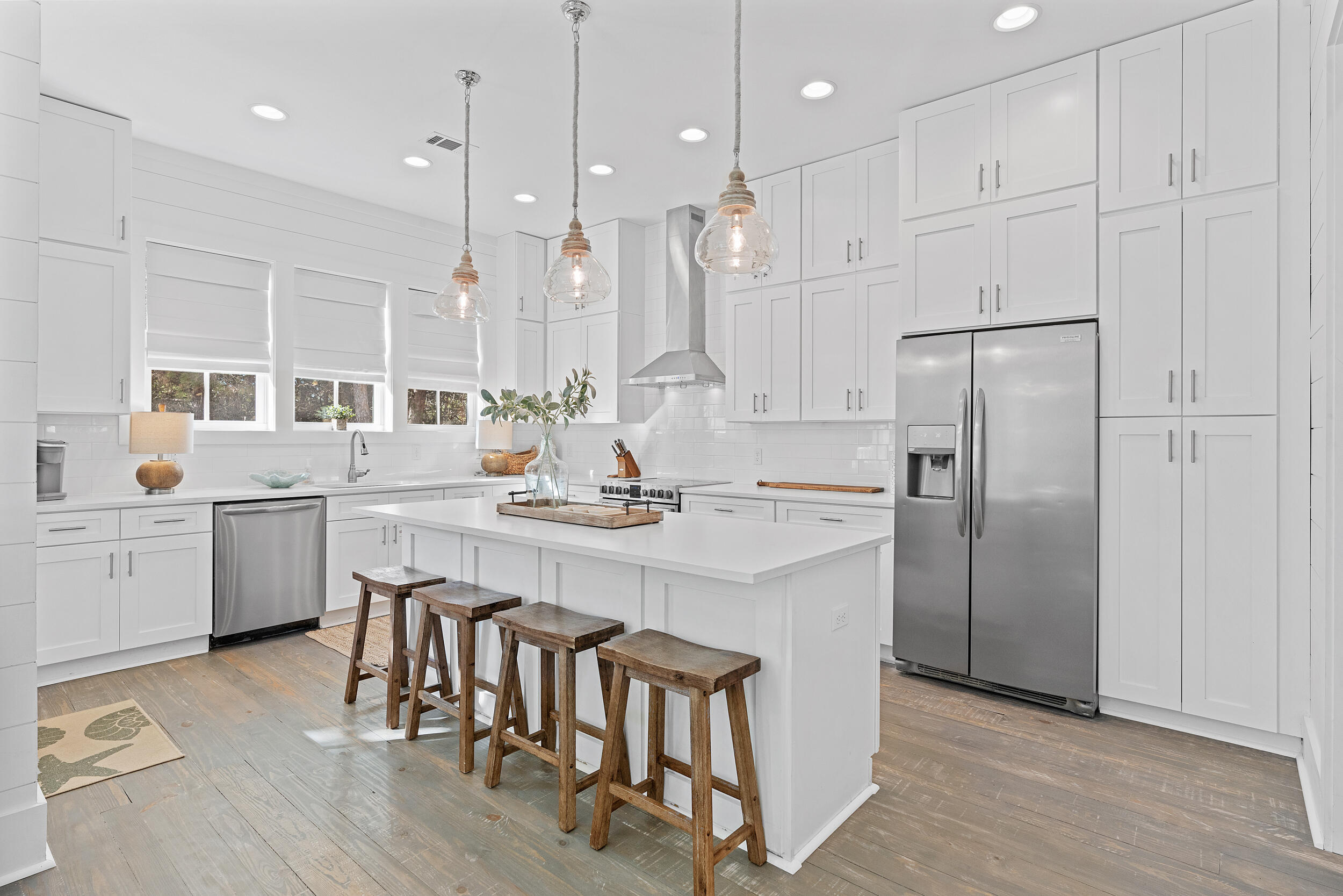 17 Pompano Court Inlet Beach, FL 32461 - Photo 20 of 48 a kitchen with stainless steel appliances granite countertop a refrigerator a sink dishwasher a stove and white cabinets with wooden floor