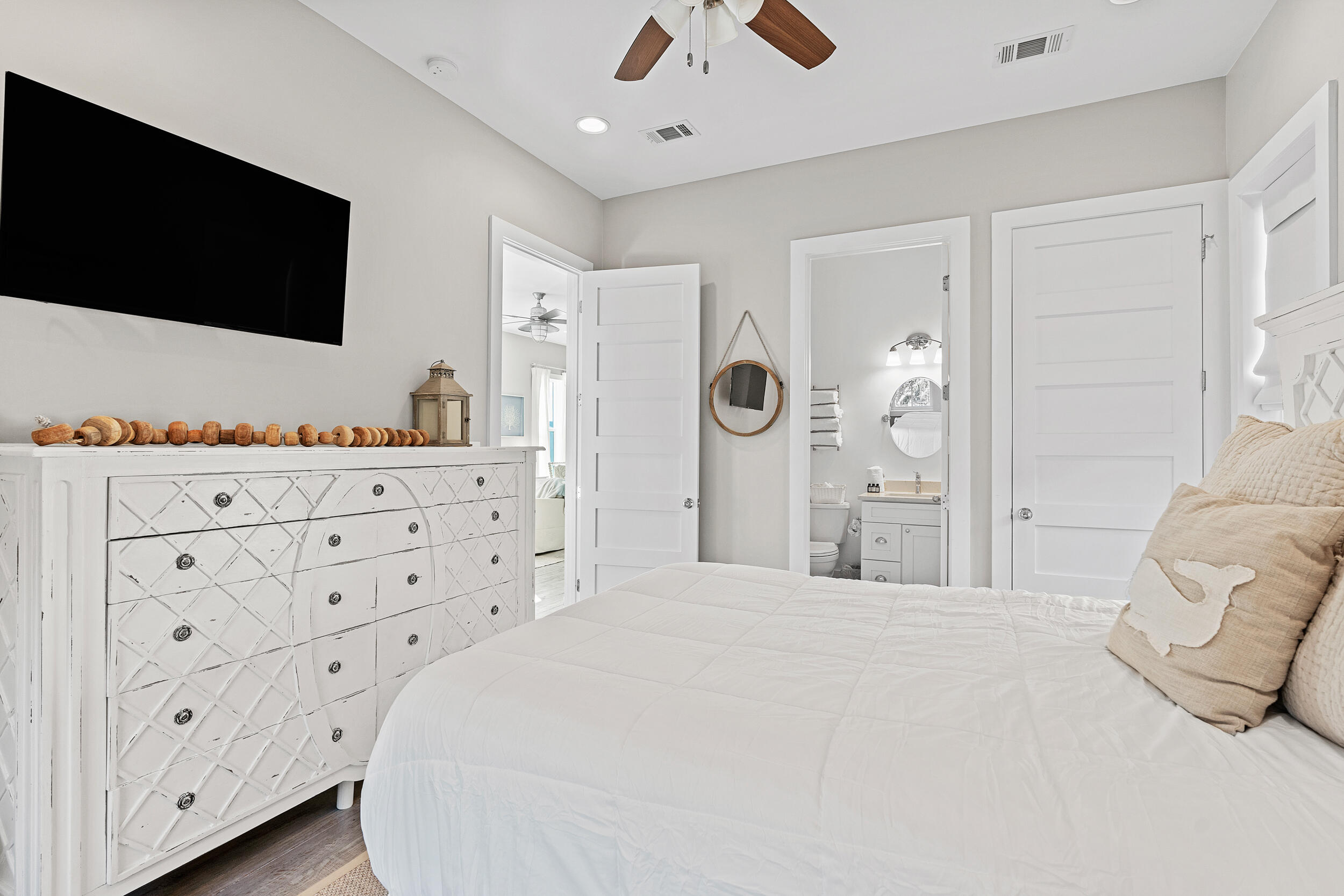 17 Pompano Court Inlet Beach, FL 32461 - Photo 27 of 48 a bedroom with a large bed and a flat tv screen on dresser