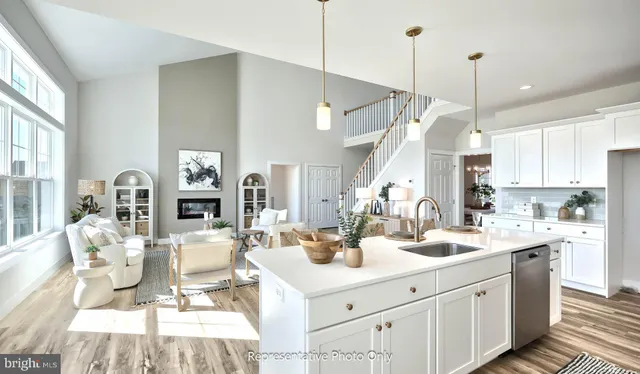 a kitchen with a sink a counter space appliances and cabinets