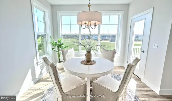 a dining room with furniture and a potted plant