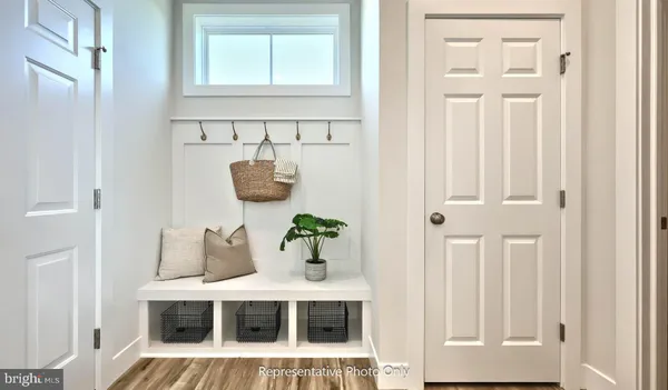 a view of a bedroom with wooden floor and cabinet