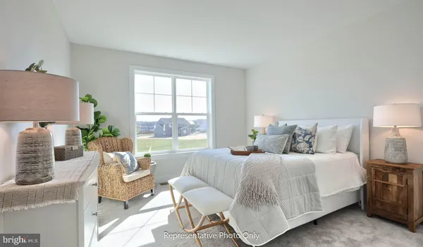 a bedroom with a bed and large window