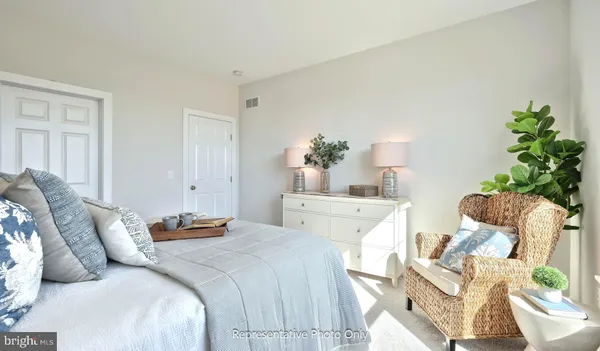 a bedroom with bed and a potted plant