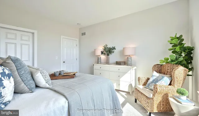 a bedroom with bed and a potted plant