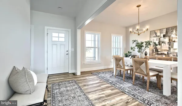 a living room with furniture a window and a chandelier