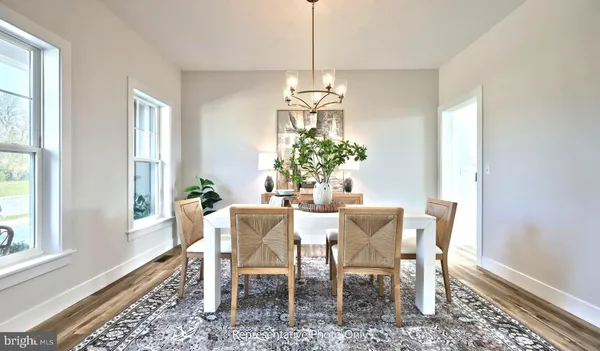 a dining room with furniture a chandelier and window