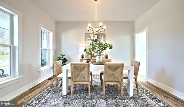 a dining room with furniture a chandelier and window